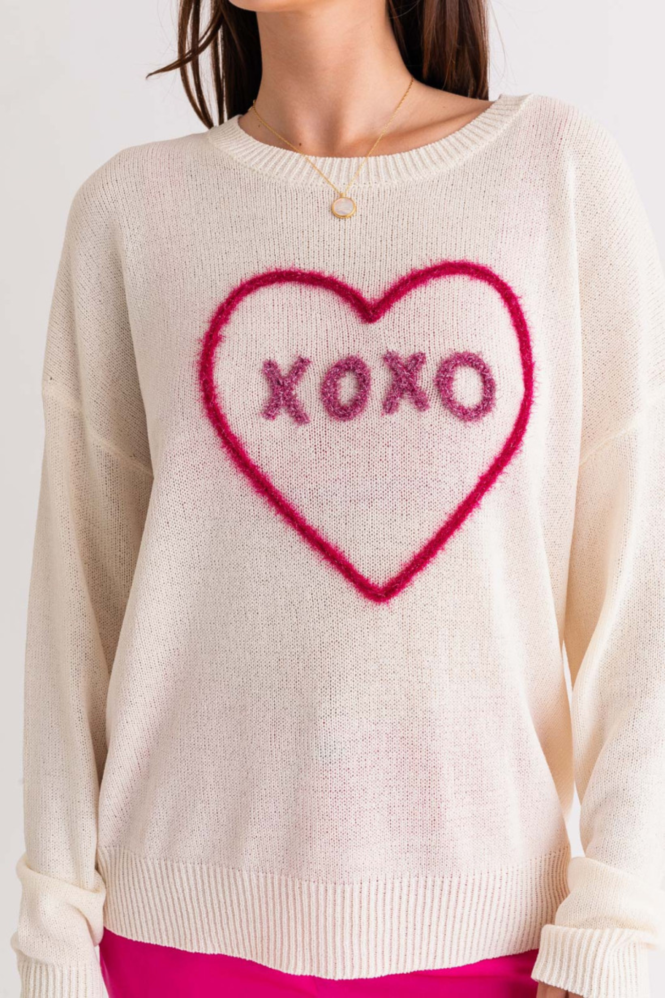 A stylish XOXO sweater top by Larrea Cove, featuring a cozy design. The sweater is paired with trendy sunglasses, emphasizing a chic and fashionable look. Ideal for casual wear, this new product is available on sale, tagged under sweaters in the apparel category.
