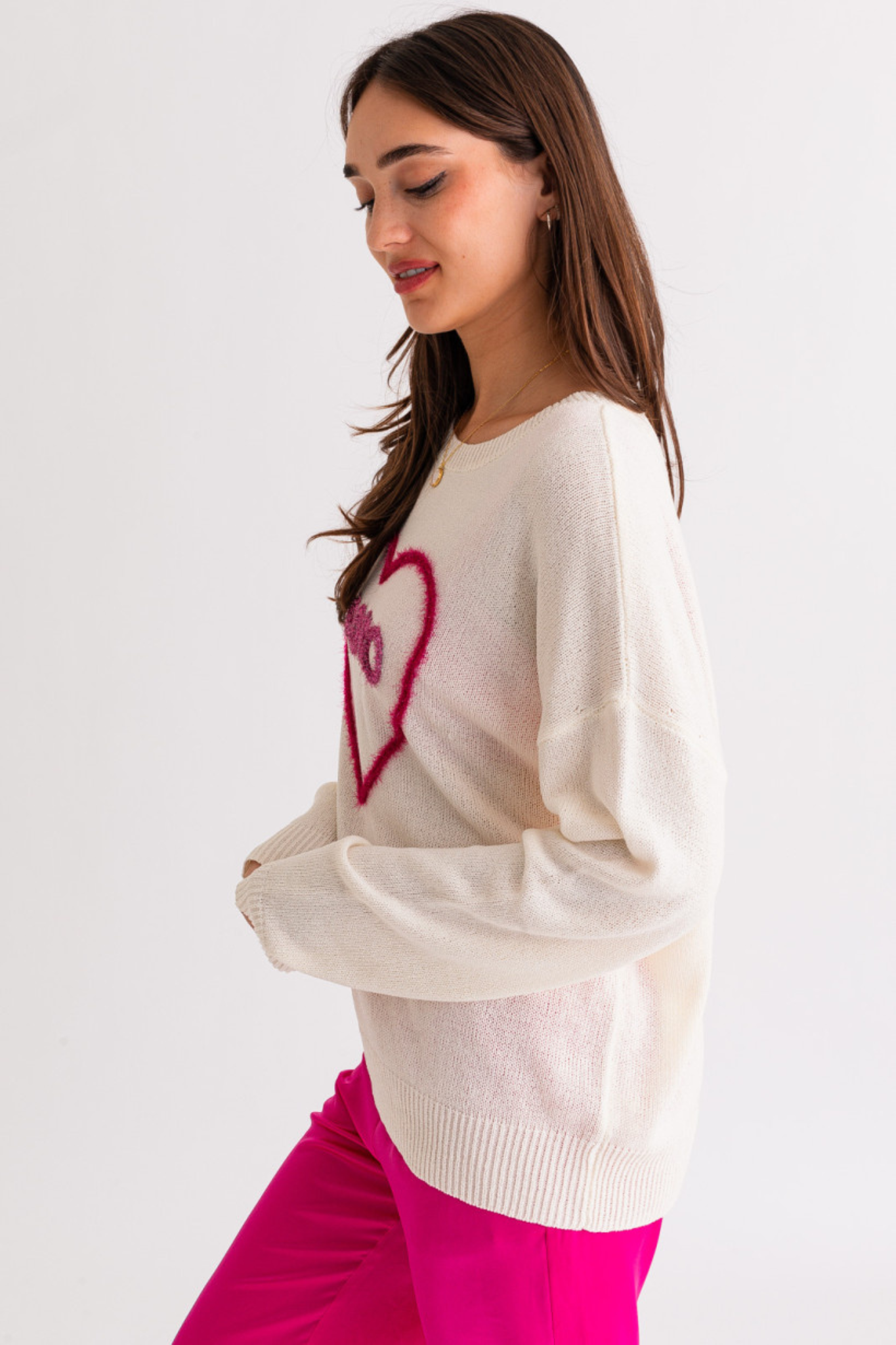 The image features a stylish XOXO sweater top by Larrea Cove, designed for a fashionable look. The sweater has a cozy knit texture and is likely in a trendy color. Sunglasses are also included in the image, suggesting a chic, casual outfit. The product is tagged with various categories and promotional information, indicating it's part of a sale and was introduced in late 2022.