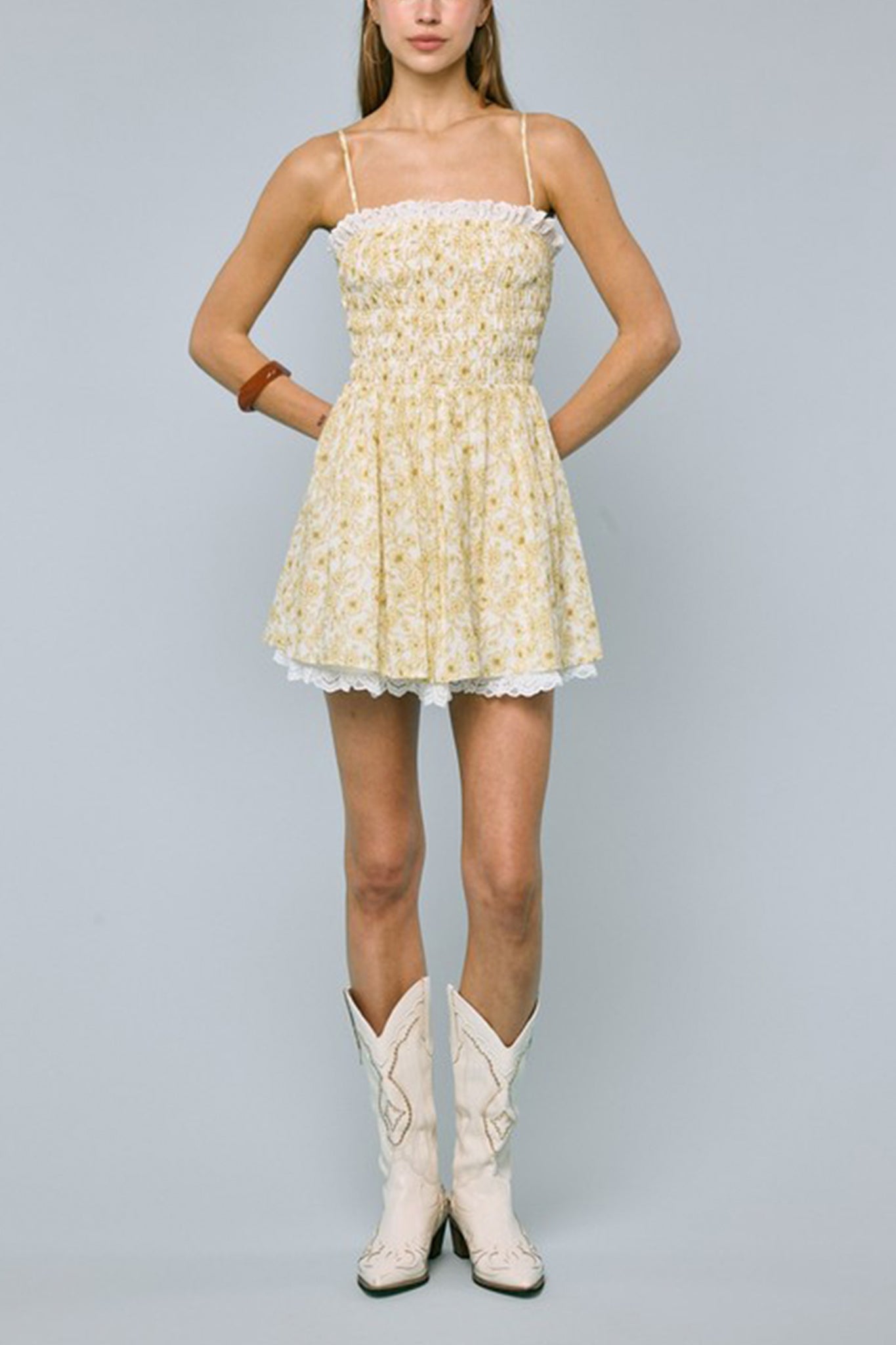 Embrace boho elegance with Larrea Cove's Floral Lace Mini Dress in a sunlit garden setting, ideal for coastal adventures.