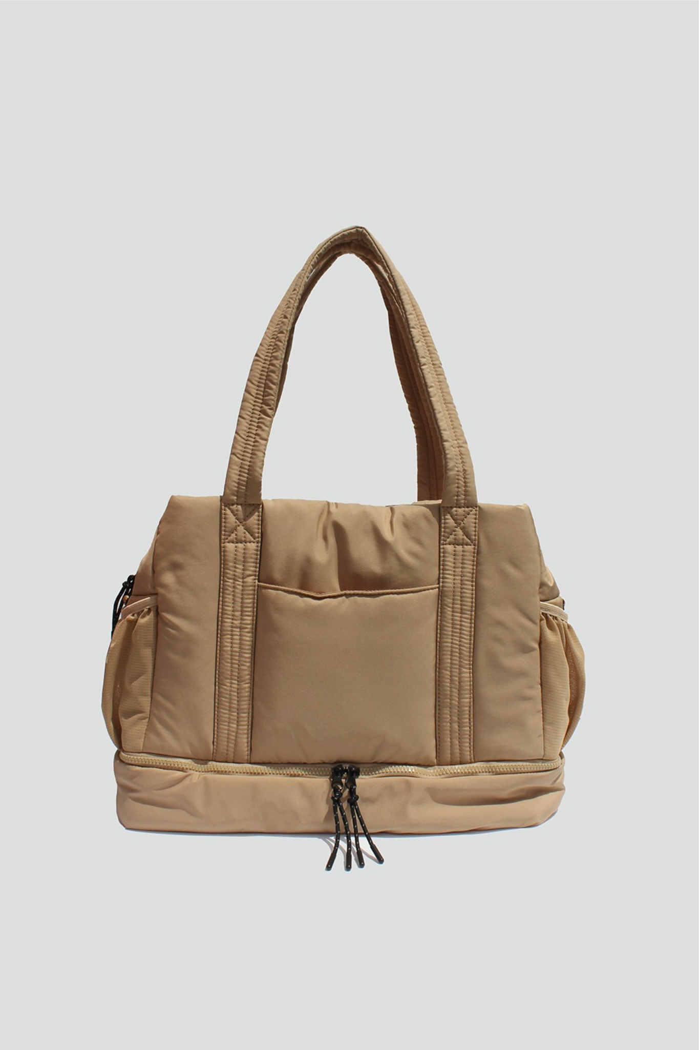 View 1 of Brooke Puffy Overnight Bag in Sand, a Bags from Larrea Cove. Detail: Introducing Brooke – the perfect companion for weekend getaways a...