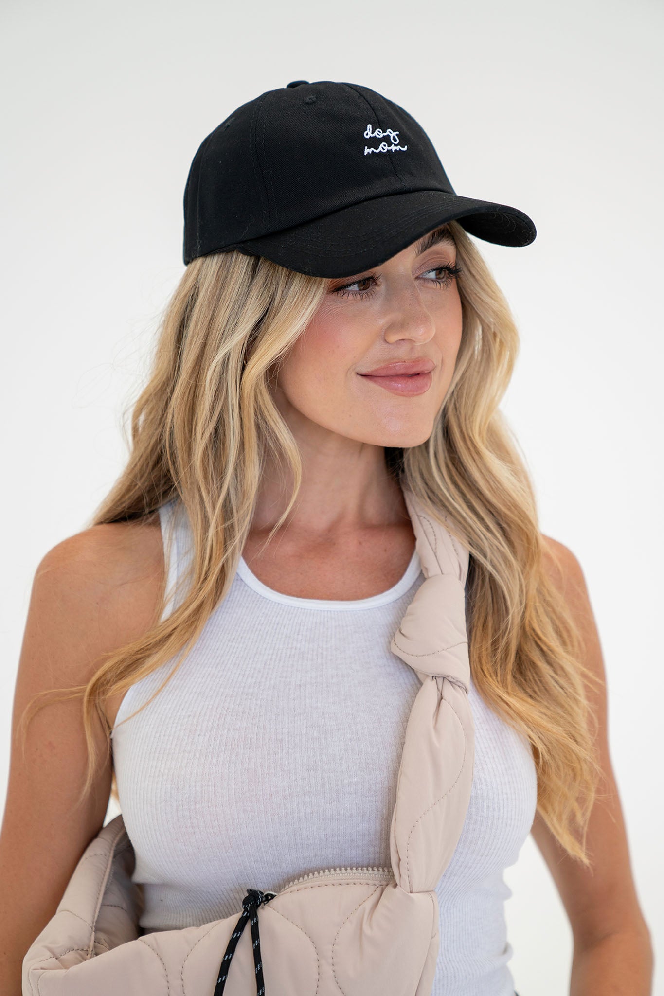 View 1 of Dog Mom Hat in Black, a Hats from Larrea Cove. Detail: This classic dad hat features the slogan "dog mom" embroi...