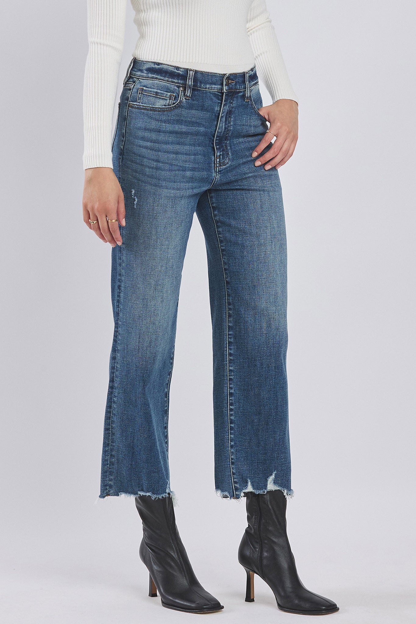 A pair of Eunina Dawn Wide Leg Jeans in a bright suncup color, featuring a relaxed fit and a high waist. The jeans are styled with a modern, trendy look, suitable for casual wear. The image may also include sunglasses as an accessory.