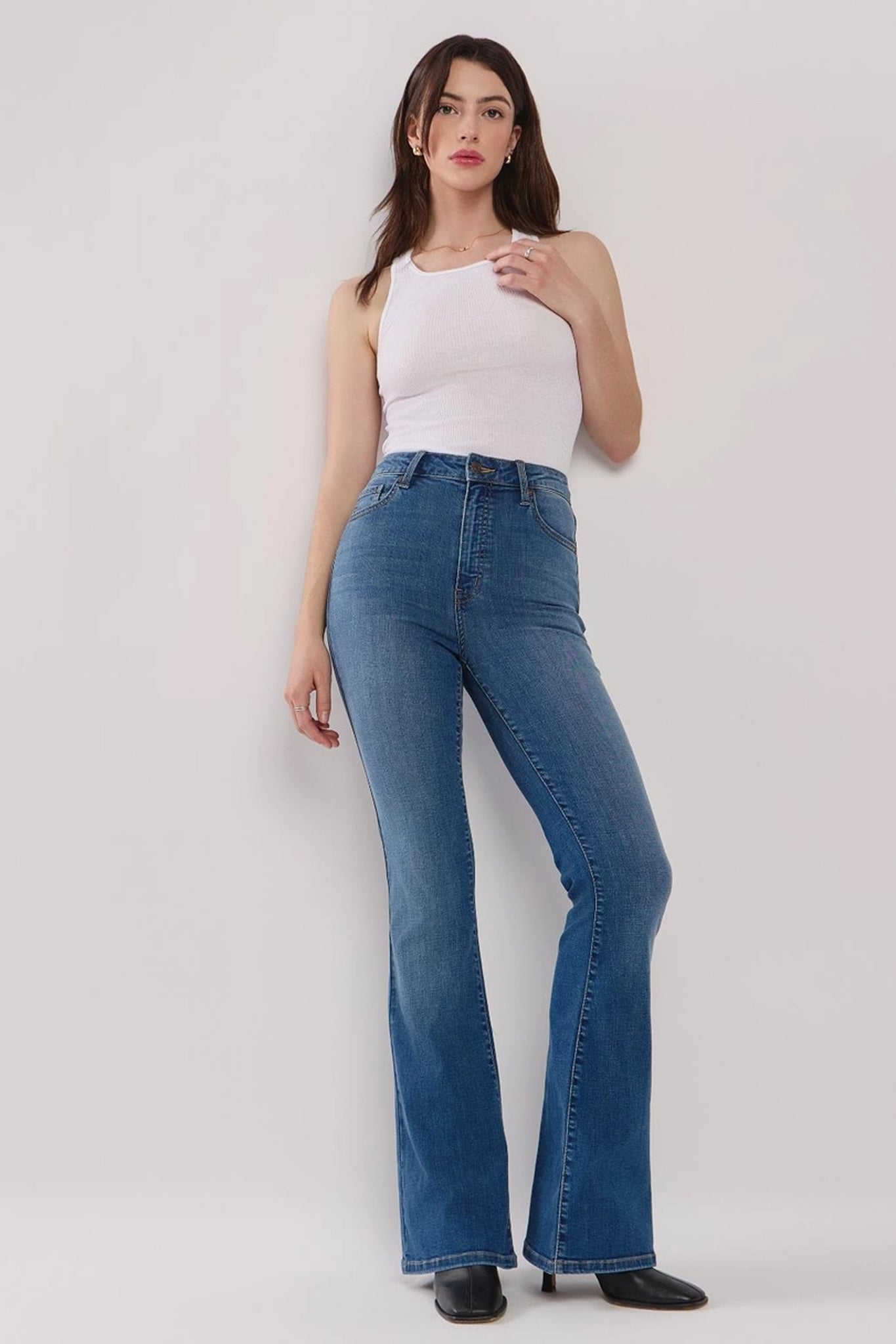 Eunina Juliana High Rise Flare Jean in Gilia, featuring a stylish high-rise fit and flare leg design. The jeans are displayed alongside a pair of sunglasses, emphasizing a trendy casual look. Tags include jeans, coupon, and vendor information.