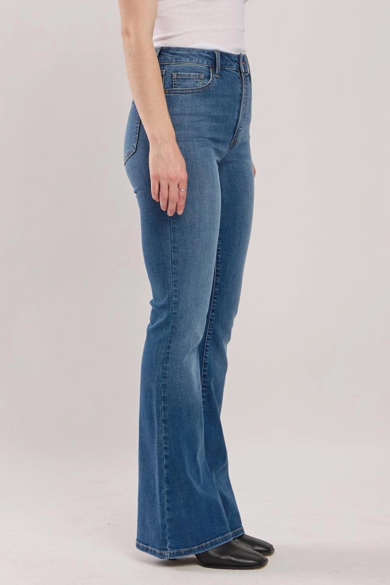 Eunina Juliana High Rise Flare Jean in Gilia, showcasing a stylish design with a high waist and flared legs, paired with trendy sunglasses. The jeans are part of the Eunina brand's 2024 collection.