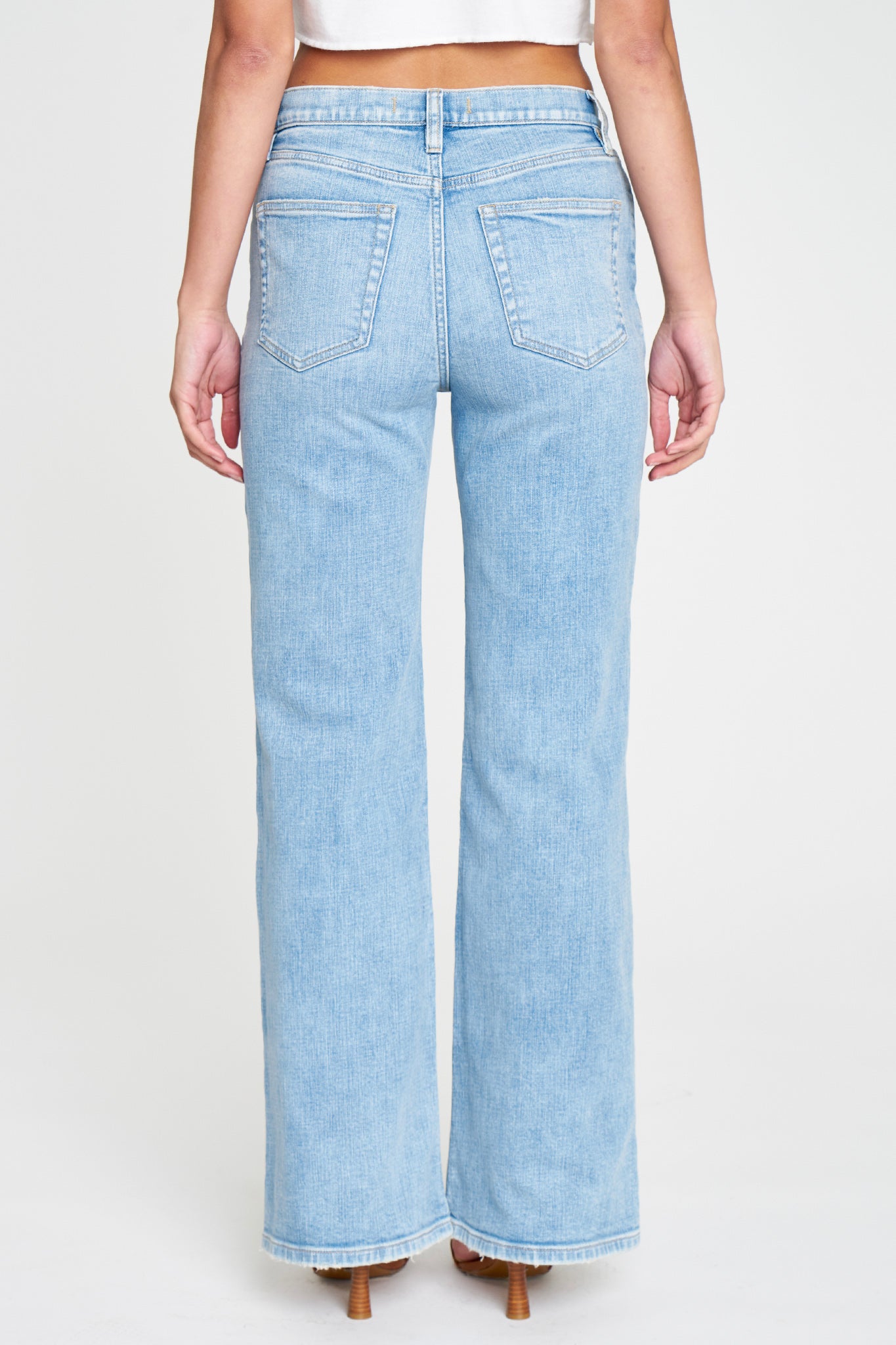 A pair of Eunina Ryder Baggy Jeans in the Ethos style, featuring a relaxed fit and light wash denim. The jeans are styled with a pair of trendy sunglasses placed beside them, emphasizing a casual, fashionable look.