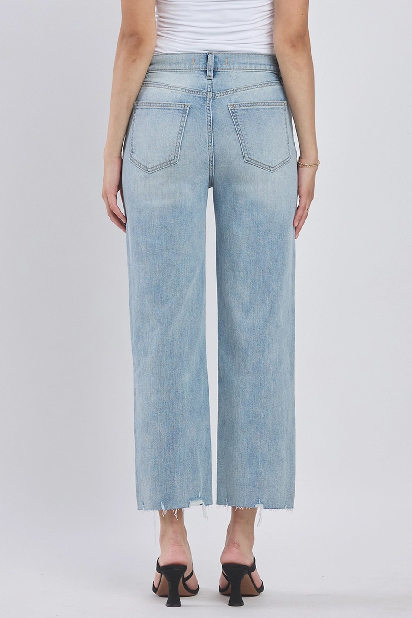 A pair of Eunina Dawn Wide Leg Jeans in a vibrant sunset color. The jeans feature a relaxed fit with a wide leg silhouette. Accompanying the jeans is a stylish pair of sunglasses. The product is tagged with various keywords related to its category and vendor.