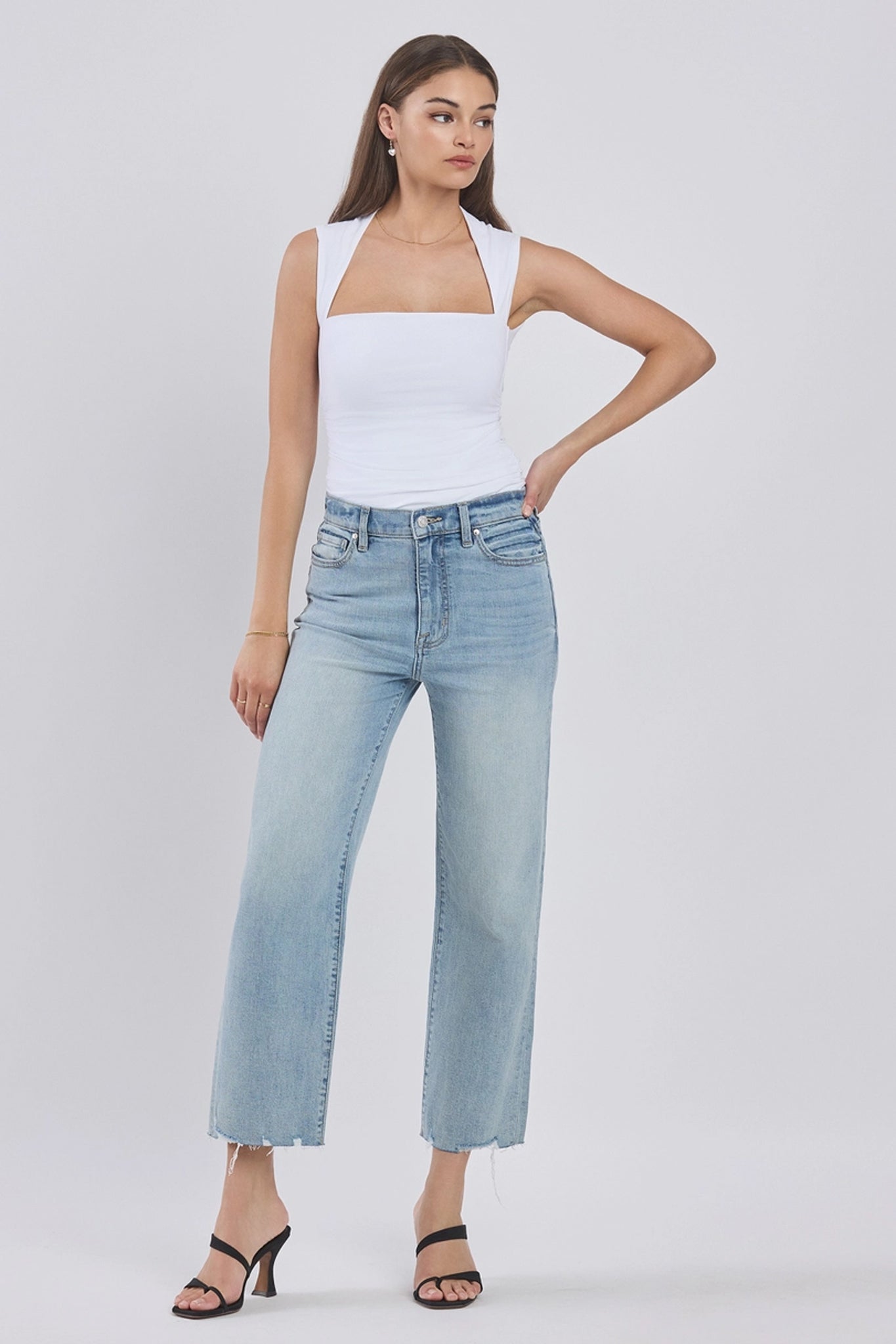 A pair of Eunina Dawn Wide Leg Jeans in a vibrant "Sunsets" colorway, featuring a relaxed fit and wide legs. The jeans are styled with sunglasses placed nearby, enhancing the casual look. The background is neutral, emphasizing the jeans' bold hues.