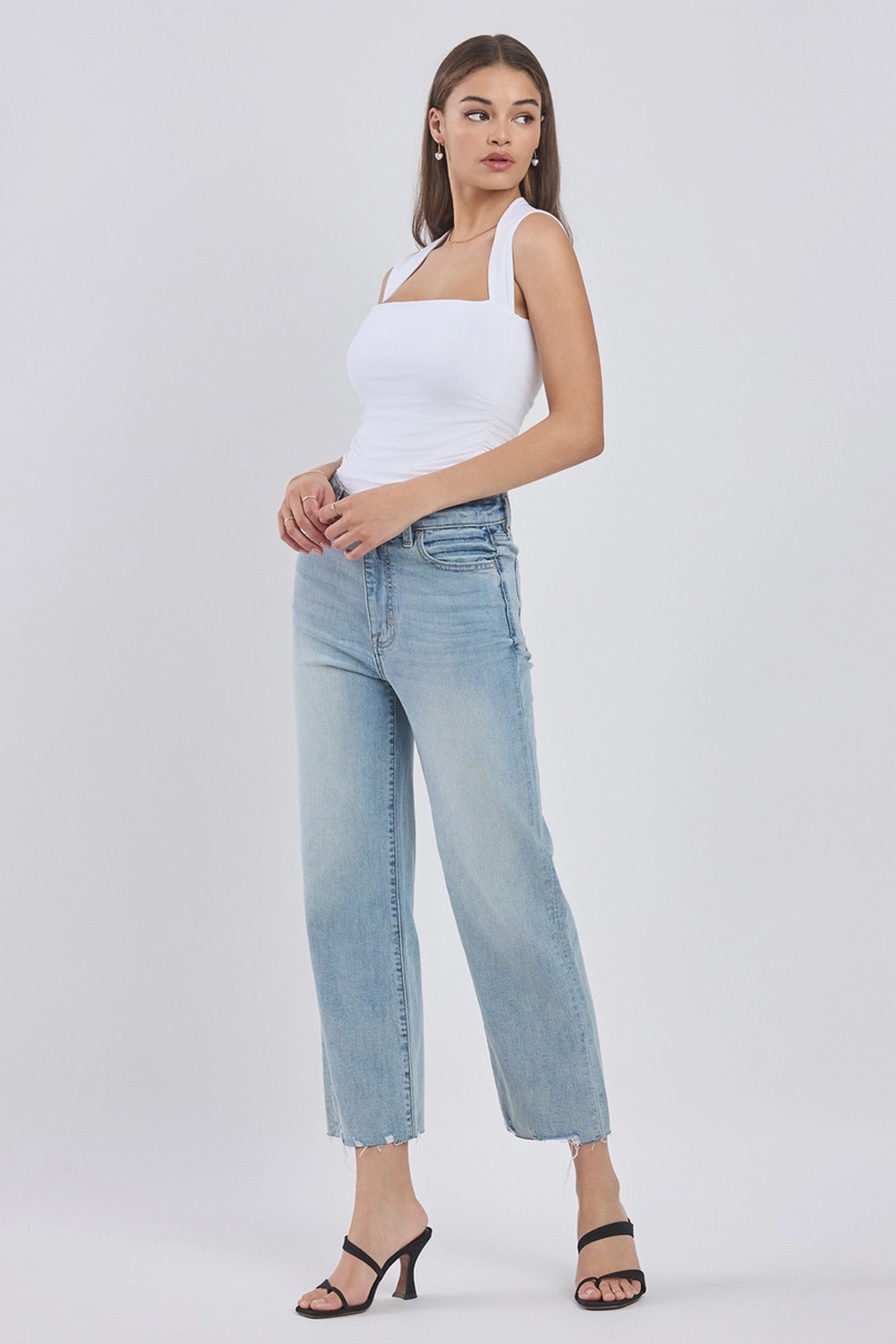 Eunina Dawn Wide Leg Jeans in Sunsets, featuring a vibrant sunset-inspired pattern, displayed with a pair of stylish sunglasses. The jeans have a relaxed, wide-leg fit, ideal for casual wear.