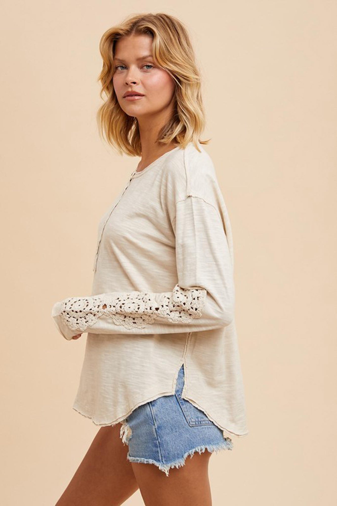 Crochet Patch Henley Top by Larrea Cove, featuring a stylish design perfect for fall 2024, displayed with complementary sunglasses.