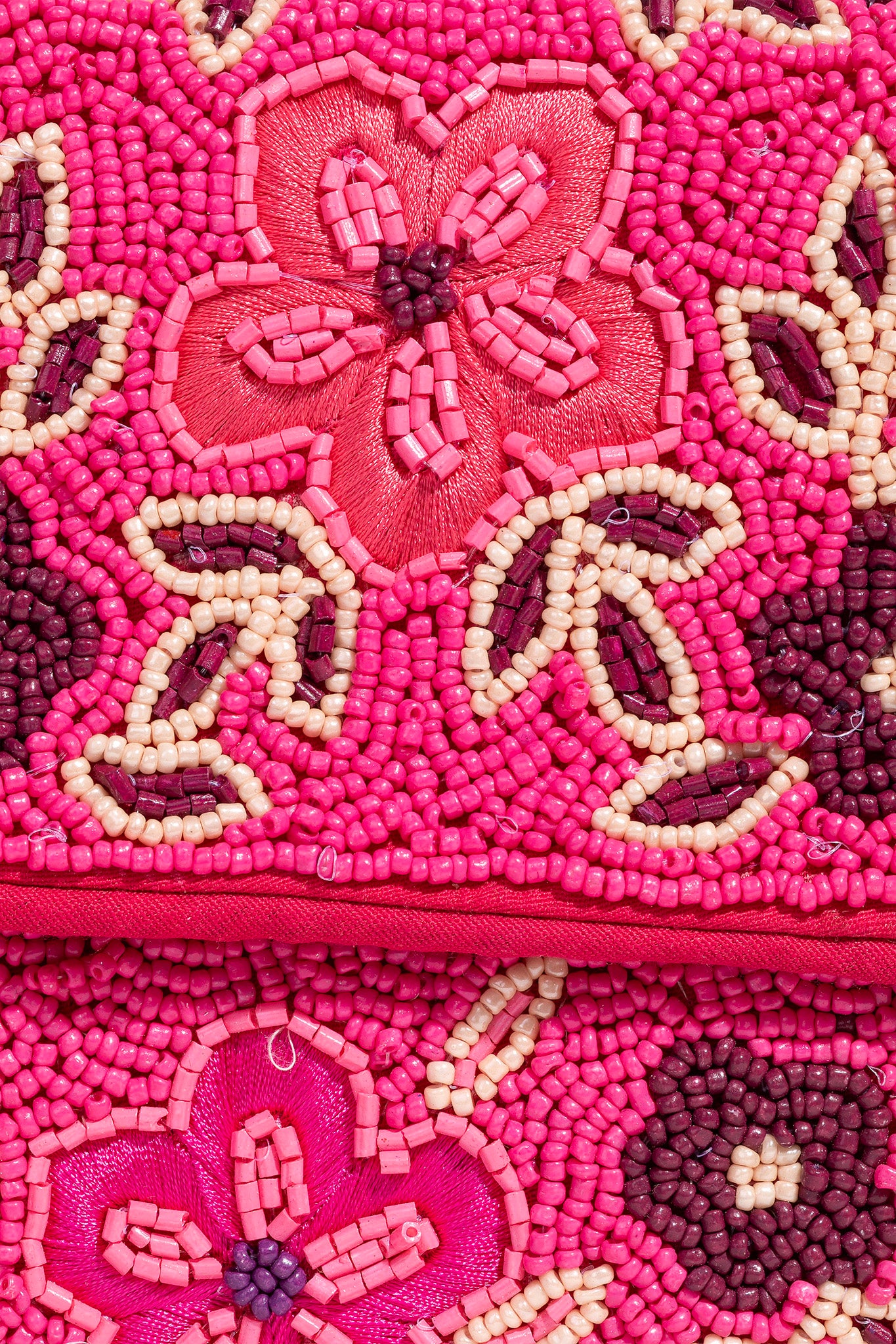 A vibrant pink shoulder bag adorned with intricate hand-beaded designs, created by ANTIK KRAFT. The bag features a stylish strap and is displayed alongside a pair of chic sunglasses. Ideal for fashion-forward individuals, it exemplifies a blend of artistry and functionality in the shoulder bag category.