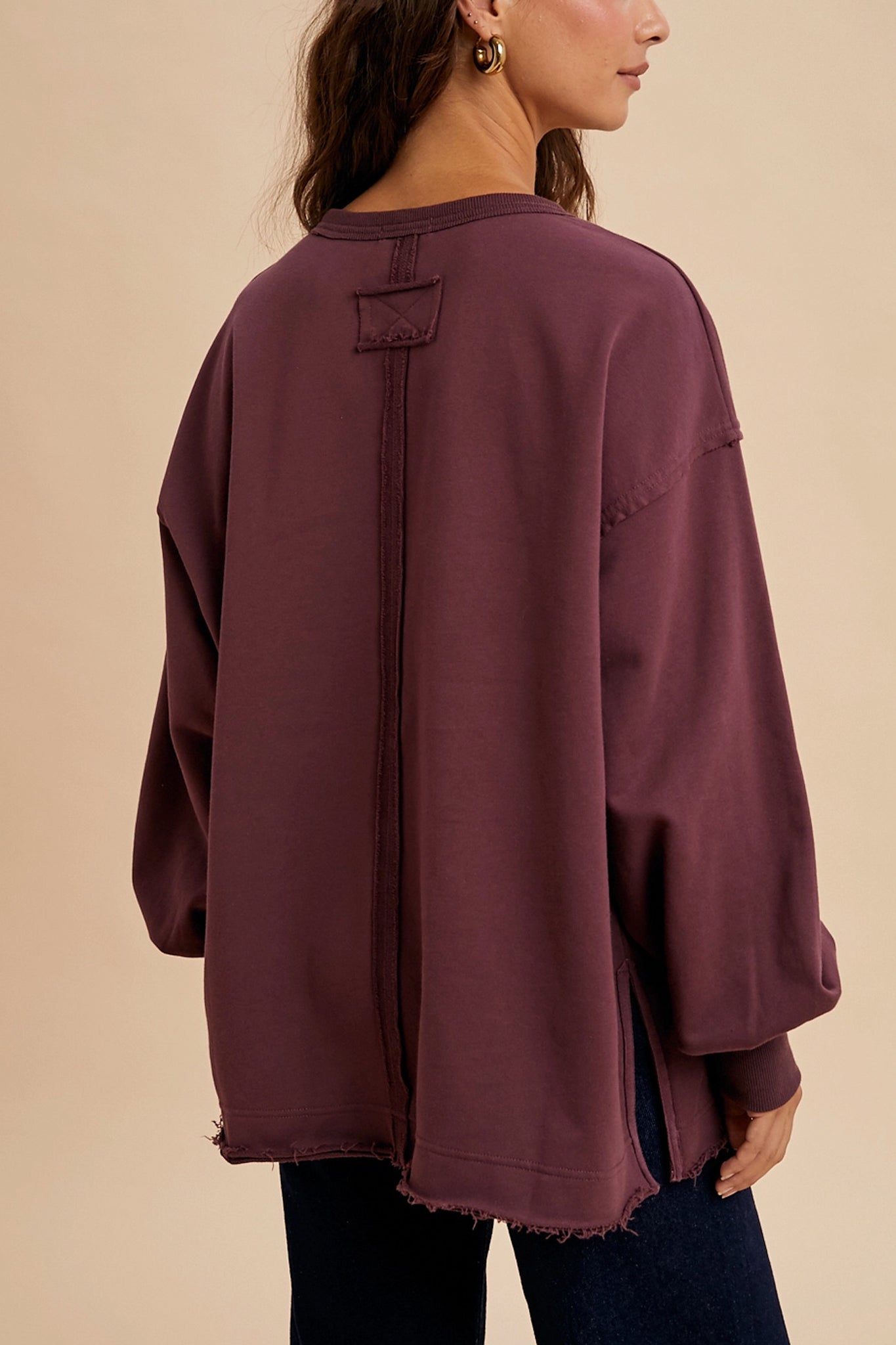 Vintage varsity oversized pullover in plum exudes effortless coastal charm. Perfect outerwear for layering in boho style.