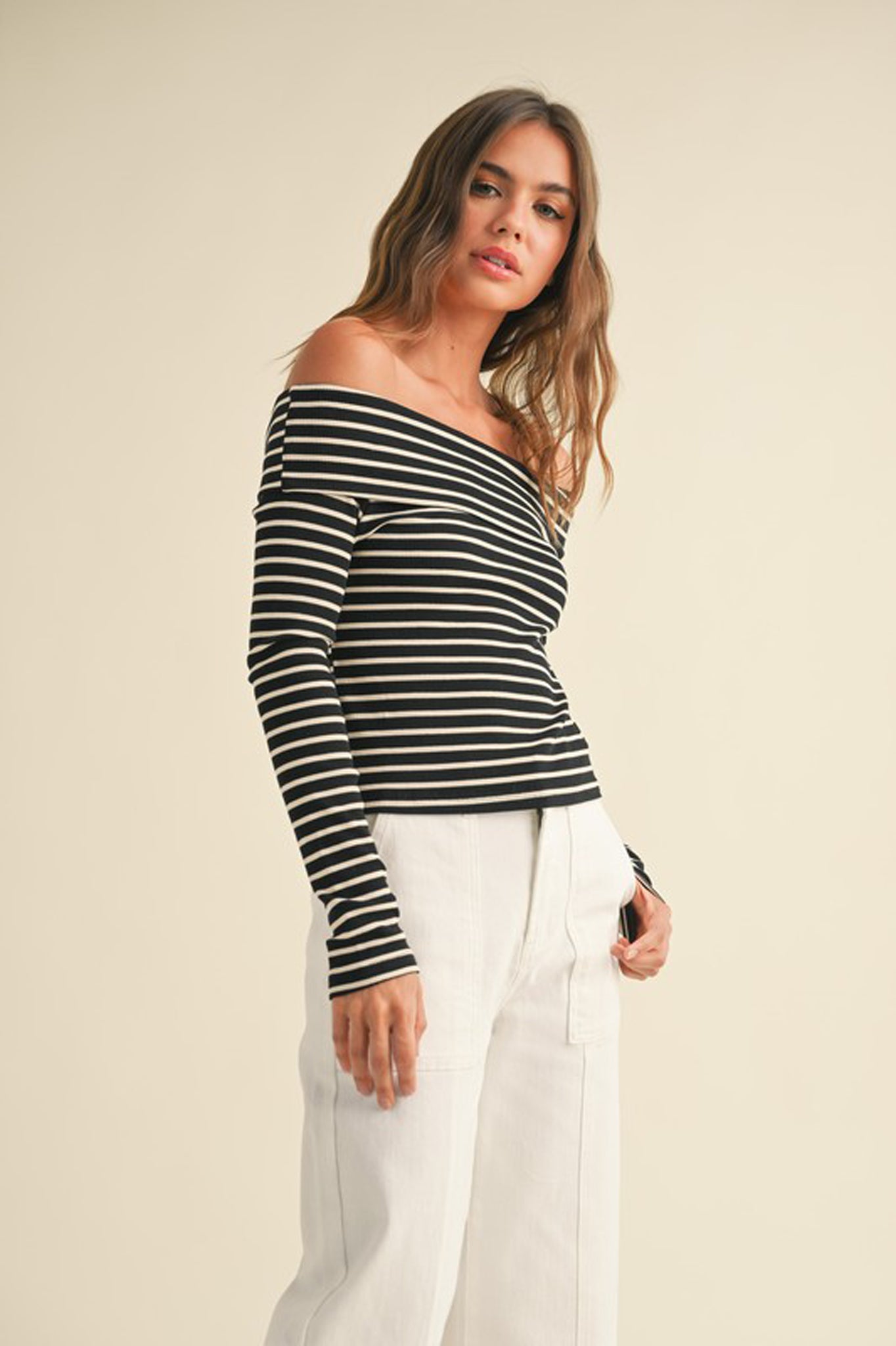 A ribbed long-sleeve off-the-shoulder top by Larrea Cove, featuring a stylish design suitable for fall. The top is paired with sunglasses, highlighting a trendy look. The image is tagged for Fall 2024 fashion and categorized as "Uncategorized.