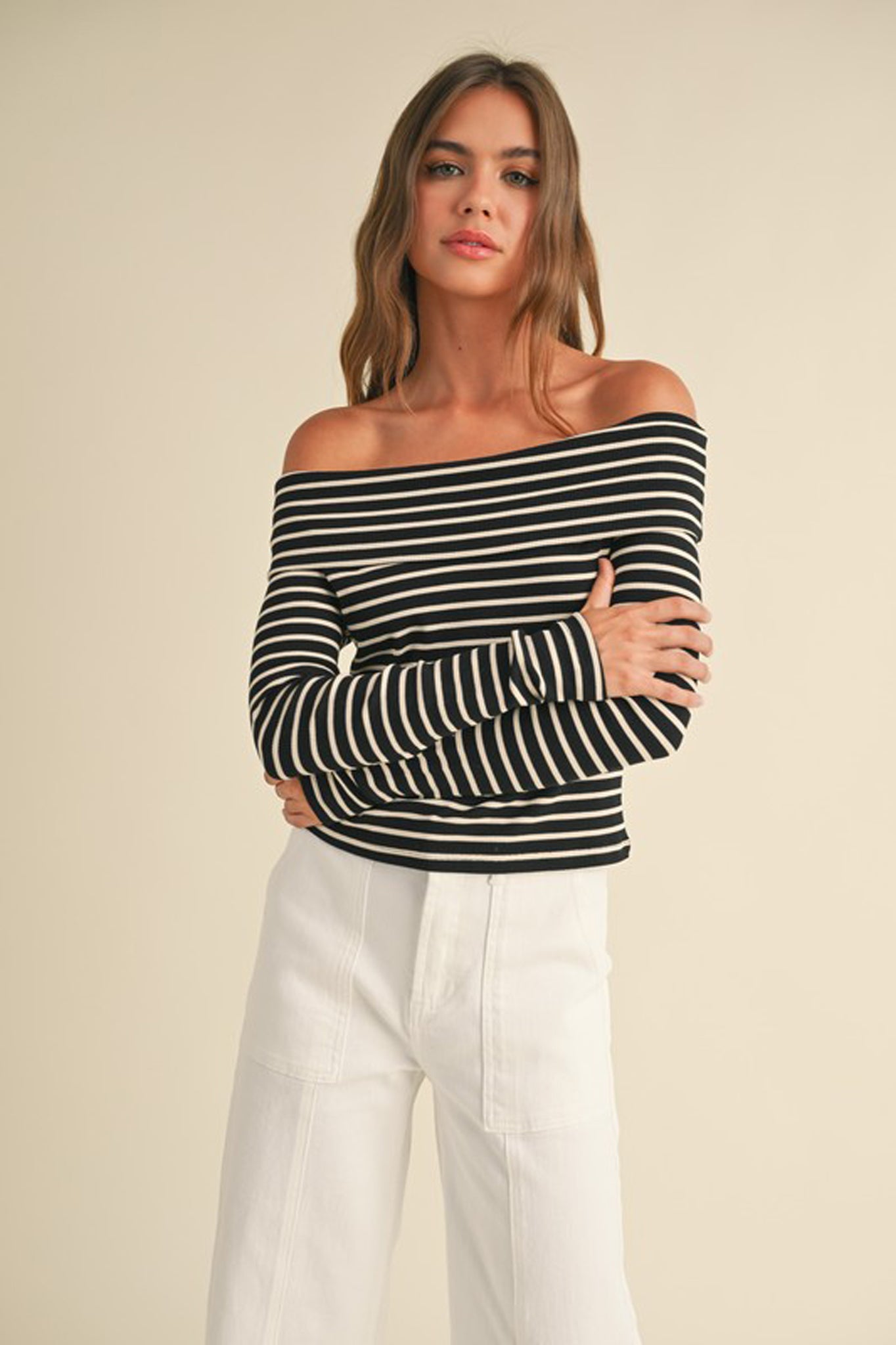 A ribbed long-sleeve off-the-shoulder top in a stylish design by Larrea Cove, made from a blend of 65% polyester, 30% rayon, and 5% spandex. The top is featured in a cozy fall 2024 collection, ideal for casual wear.