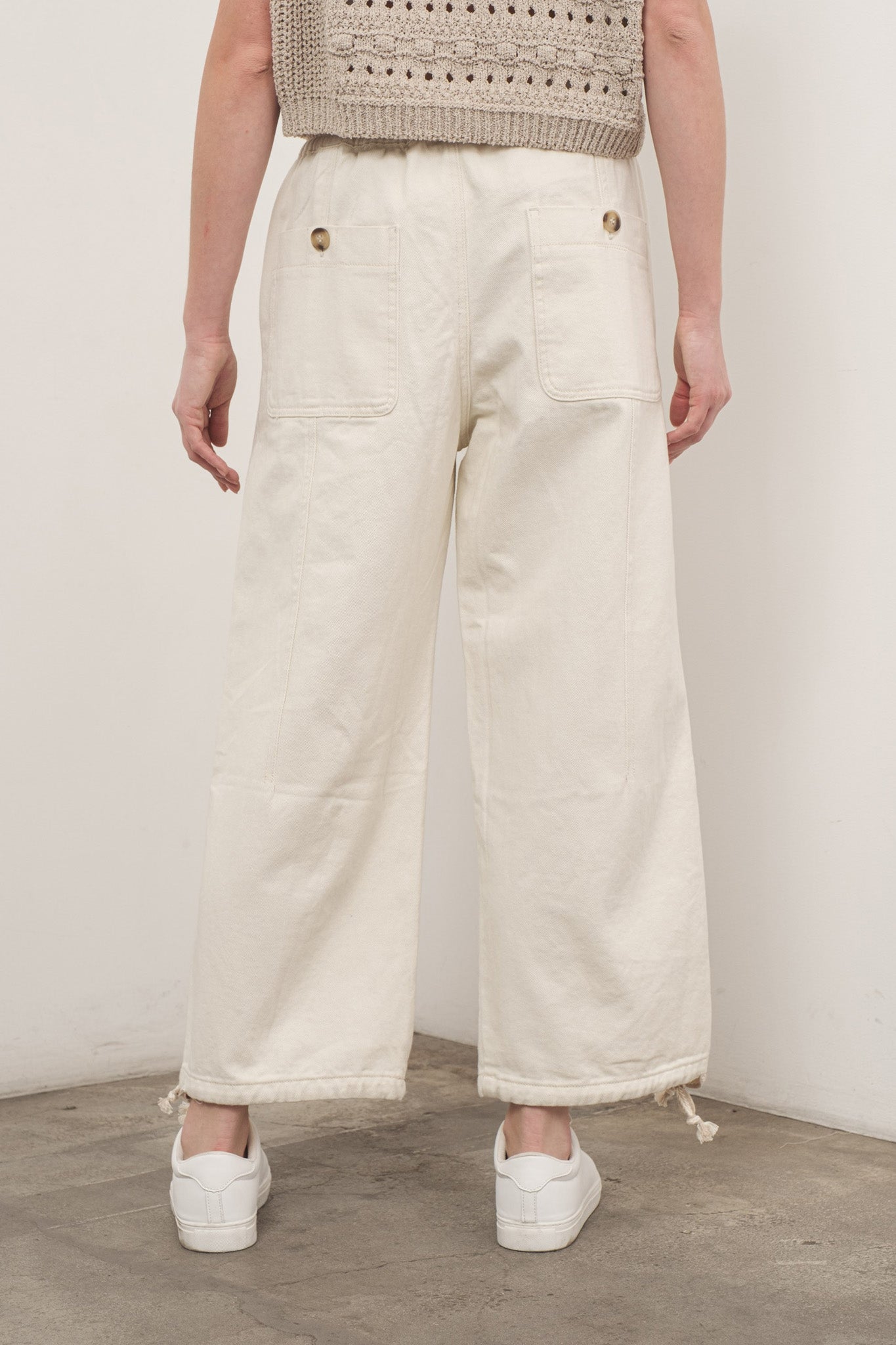 A pair of Sands Pull-On Pants by Larrea Cove, designed for comfort and style. The pants feature a relaxed fit and elastic waistband, perfect for casual wear. The image showcases the pants in a neutral color, suitable for various outfits. Accompanying the pants are stylish sunglasses, emphasizing a trendy look.