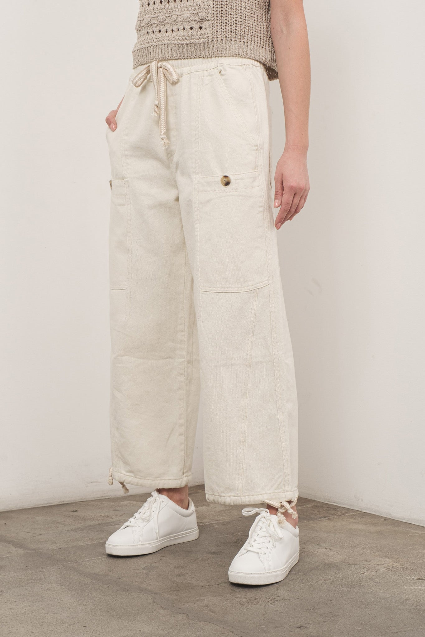 A pair of Sands Pull-On Pants by Larrea Cove, featuring a comfortable, elastic waistband and a stylish design suitable for casual wear. The pants are shown in a neutral color, making them versatile for various outfits. The image highlights the fabric texture and fit, emphasizing the ease of wear and contemporary style.