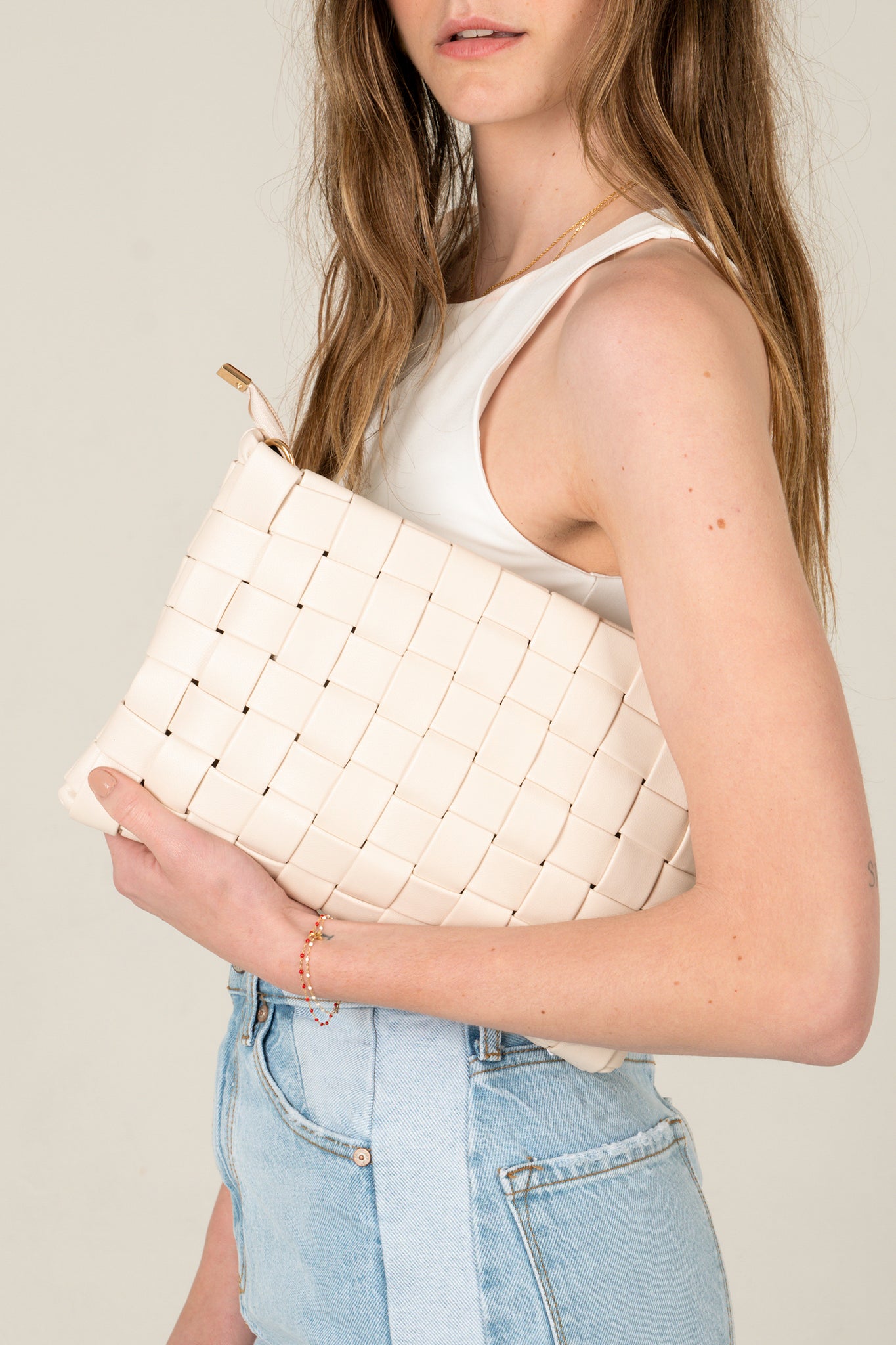 View 1 of Keen Woven Clutch in Ivory, a Bags from Larrea Cove. Detail: The Keen Woven Clutch in Ivory is a stylish and practical accessory that ...