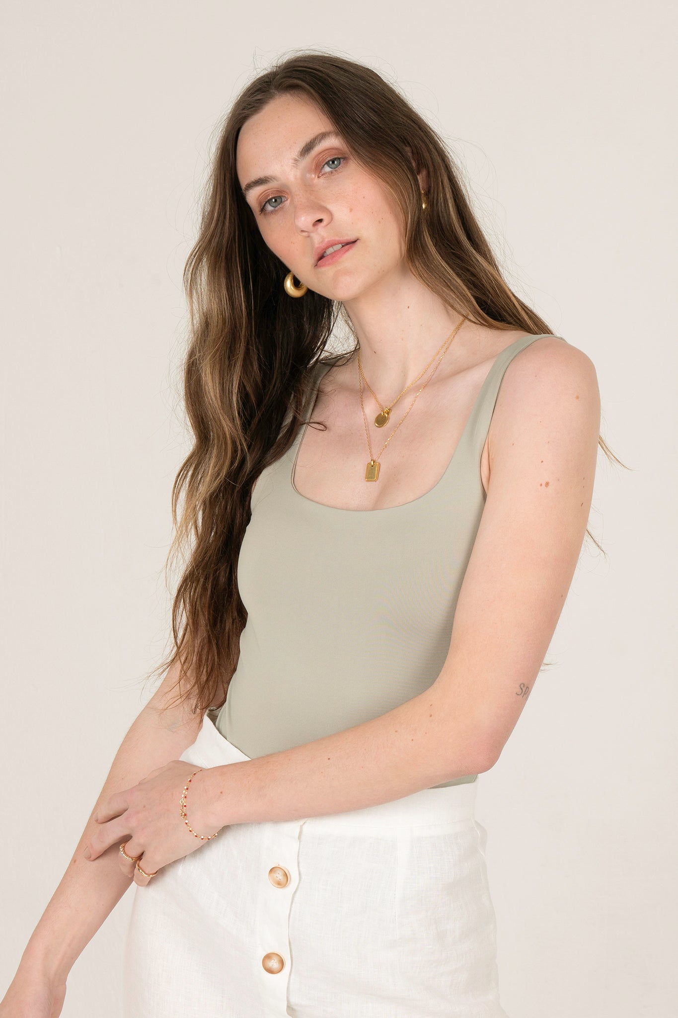 View 1 of Cara Square Neck Bodysuit in Light Sage, a Bodysuits from Larrea Cove. Detail: Achieve effortless style that’s uncomplicated and chic ...