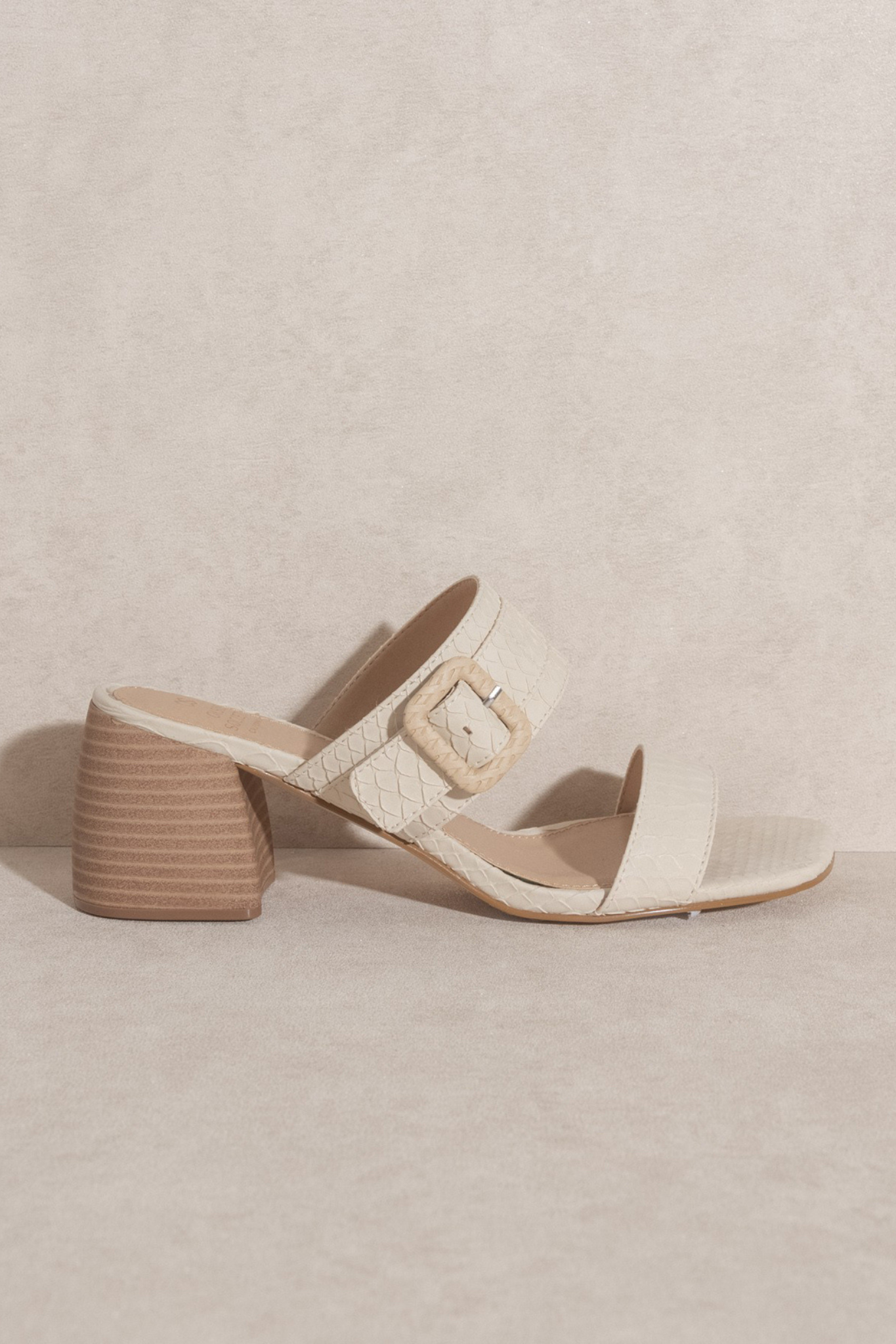 View 1 of Nicole Buckle Block Heel in Off White, a Shoes from Larrea Cove. Detail: The Nicole Buckle Block Heel in Off White is the perfect shoe...
